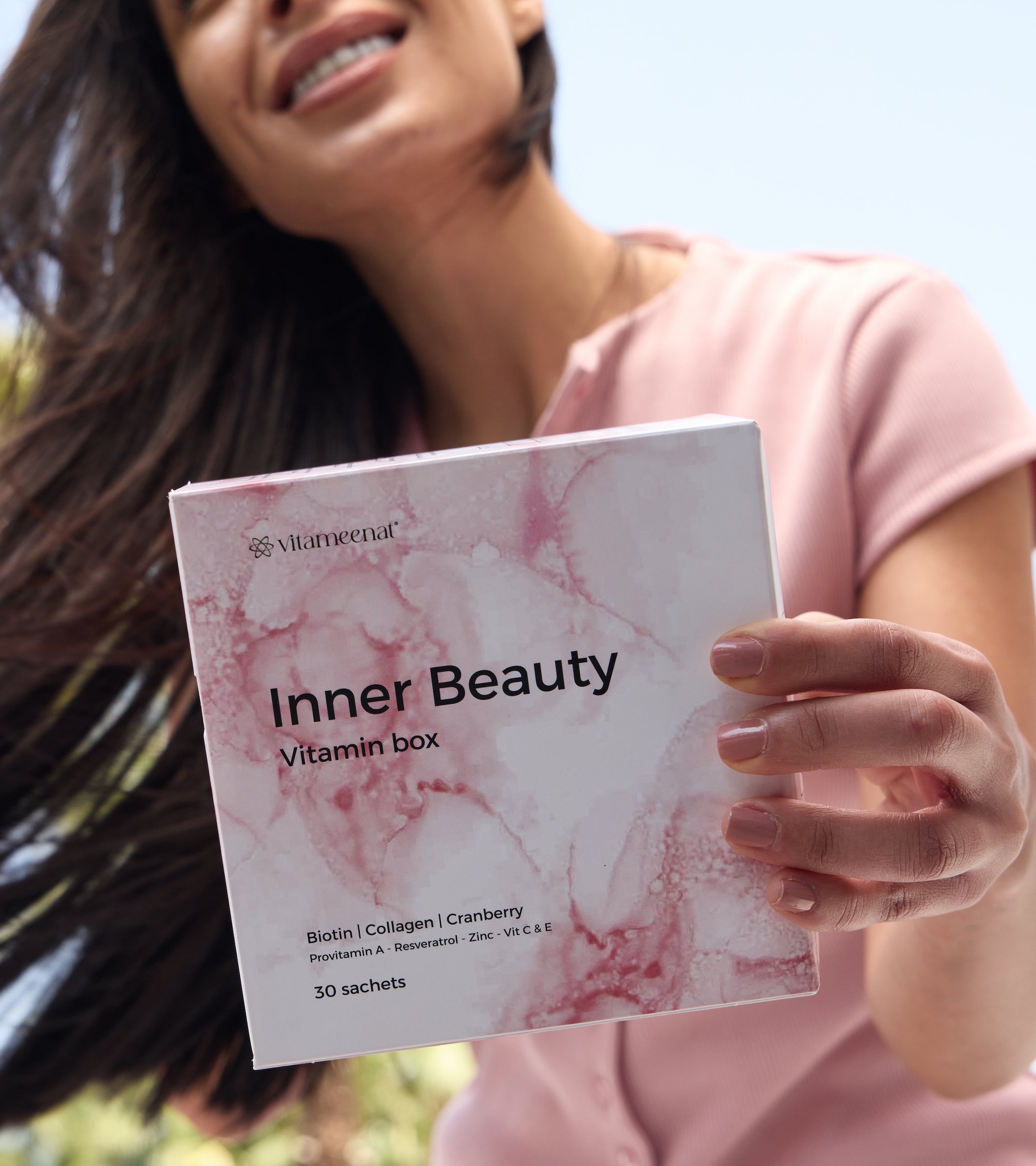 Woman holding a 'Inner Beauty Vitamin box' by vitameenat