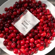 White plate with red berries and a 'Inner Beauty' sachet product packaging.